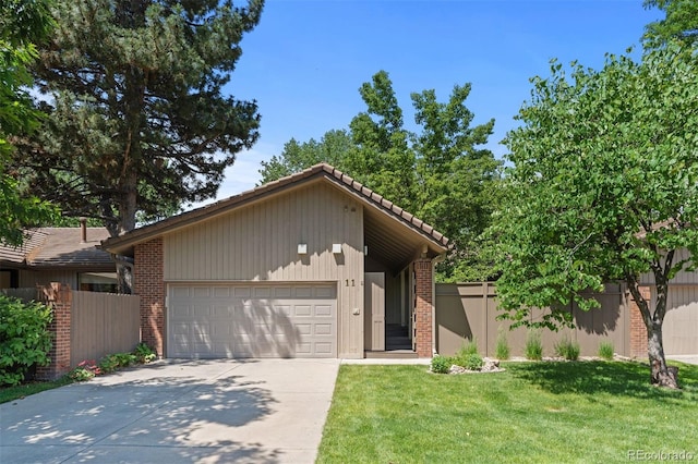 2601 S Quebec St Unit 11, Denver, CO 80231 - mid-century home with concrete driveway, brick siding, and a garage