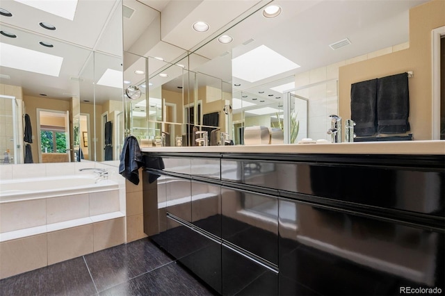 2601 S Quebec St Unit 11, Denver, CO 80231 - bathroom featuring a skylight, a garden tub, vanity, and recessed lighting