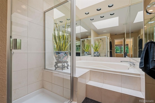 2601 S Quebec St Unit 11, Denver, CO 80231 - bathroom with a skylight, a shower stall, a bath, and recessed lighting