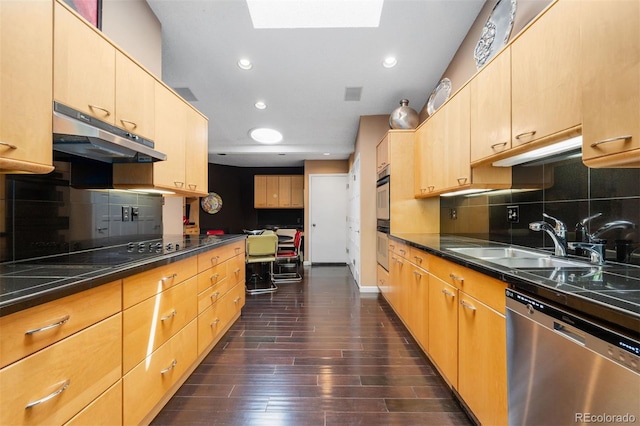 2601 S Quebec St Unit 11, Denver, CO 80231 - kitchen with stainless steel dishwasher, dark countertops, a skylight, decorative backsplash, and under cabinet range hood