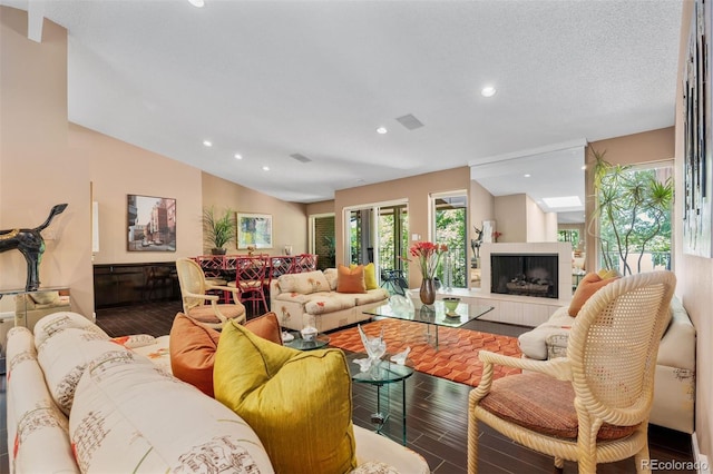 2601 S Quebec St Unit 11, Denver, CO 80231 - living room with wood finished floors, recessed lighting, a tile fireplace, and lofted ceiling