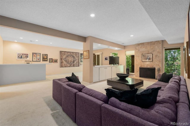 2601 S Quebec St Unit 11, Denver, CO 80231 - living room featuring a textured ceiling, light carpet, a fireplace, and recessed lighting