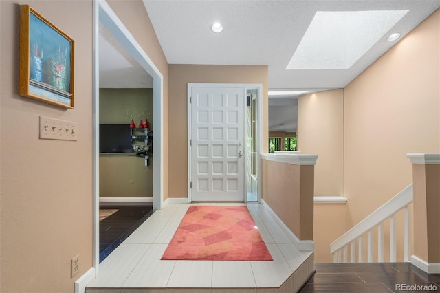 2601 S Quebec St Unit 11, Denver, CO 80231 - tiled foyer featuring a skylight and recessed lighting