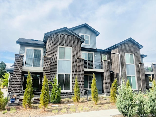 14673 E Belleview Dr, Aurora, CO 80015 - view of front of home with a balcony and brick siding