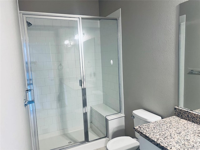 14673 E Belleview Dr, Aurora, CO 80015 - full bath featuring vanity, toilet, a shower stall, and a textured wall