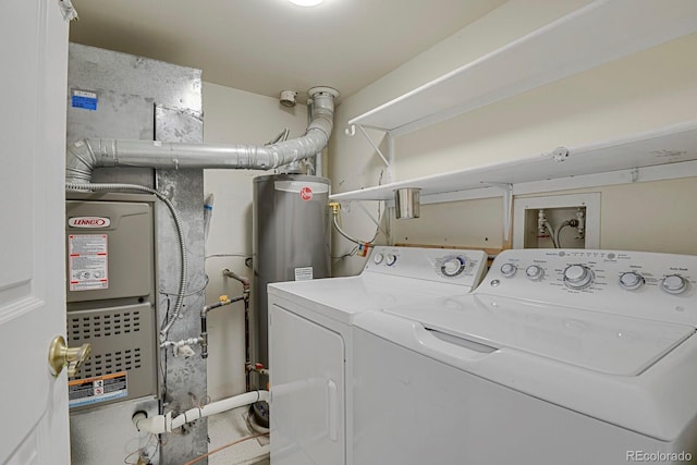 clothes washing area featuring independent washer and dryer and water heater