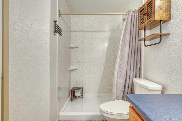 full bathroom featuring a textured wall, a shower stall, and toilet