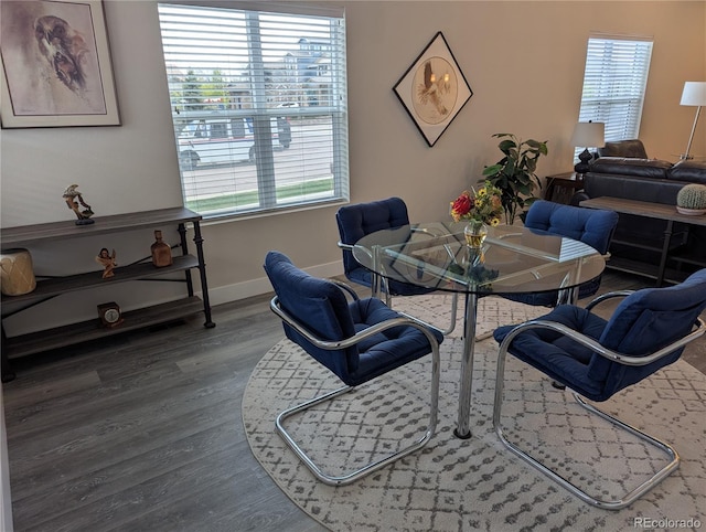 dining area featuring baseboards and wood finished floors