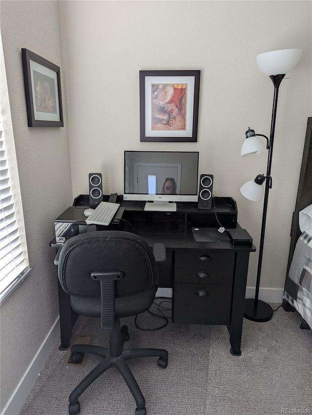office with baseboards and carpet floors