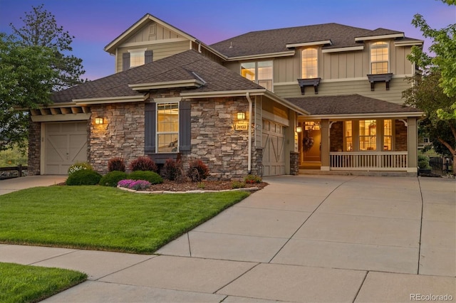 24422 E Frost Dr, Aurora, CO 80016 - craftsman inspired home featuring driveway, a garage, stone siding, board and batten siding, and a front lawn