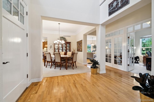24422 E Frost Dr, Aurora, CO 80016 - entrance foyer featuring a chandelier, light wood finished floors, ornamental molding, french doors, and a high ceiling
