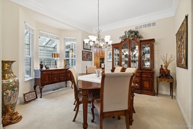 24422 E Frost Dr, Aurora, CO 80016 - dining room featuring light colored carpet, a chandelier, crown molding, and healthy amount of natural light