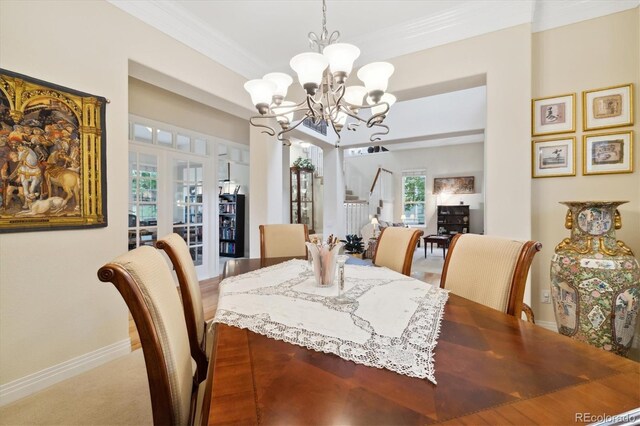 24422 E Frost Dr, Aurora, CO 80016 - dining space with a chandelier, ornamental molding, and stairs