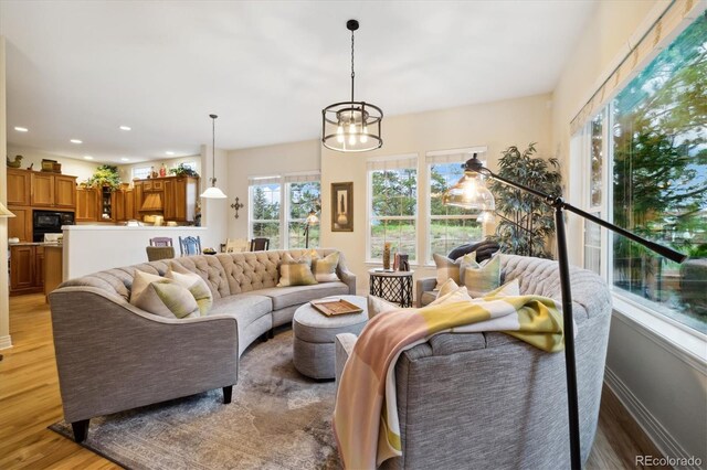 24422 E Frost Dr, Aurora, CO 80016 - living area with light wood-style flooring, a chandelier, and recessed lighting