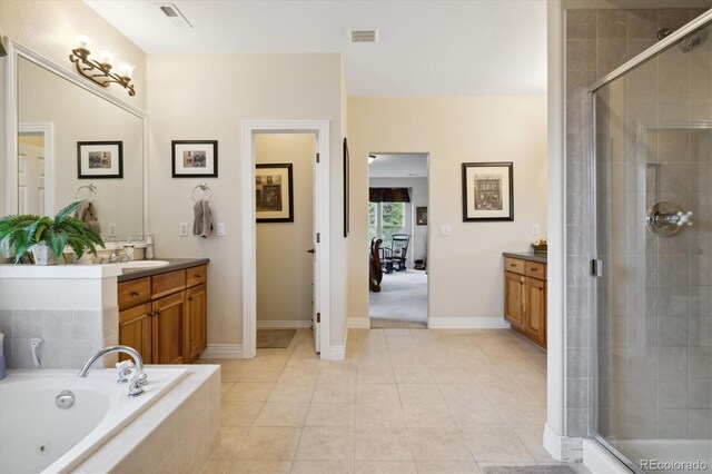 24422 E Frost Dr, Aurora, CO 80016 - bathroom featuring vanity, a stall shower, a tub with jets, and tile patterned flooring
