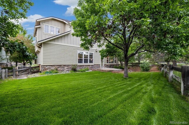 24422 E Frost Dr, Aurora, CO 80016 - rear view of house featuring board and batten siding and stone siding