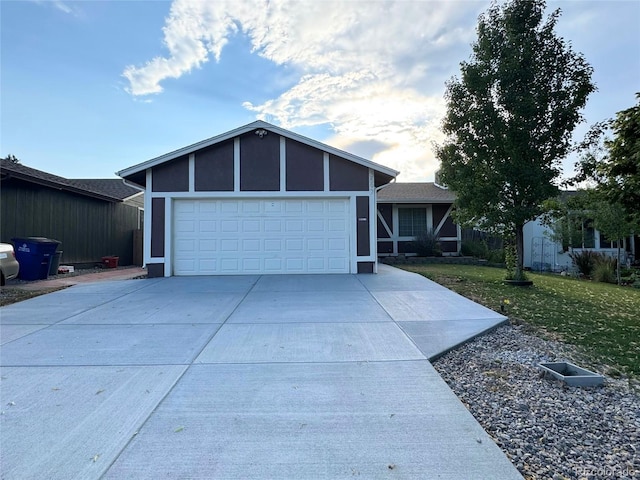 view of front of home with a garage and a front lawn