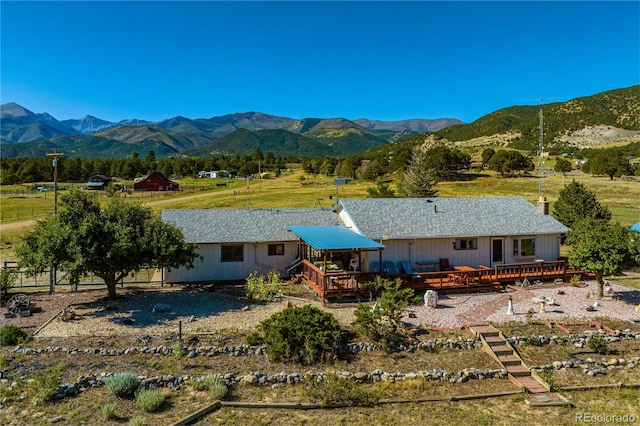 exterior space featuring a deck with mountain view