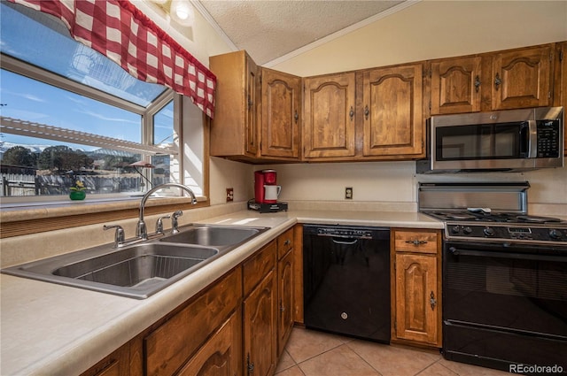 kitchen with light tile floors, sink, lofted ceiling, black appliances, and ornamental molding