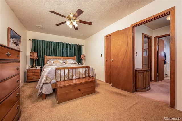 carpeted bedroom featuring a textured ceiling and ceiling fan