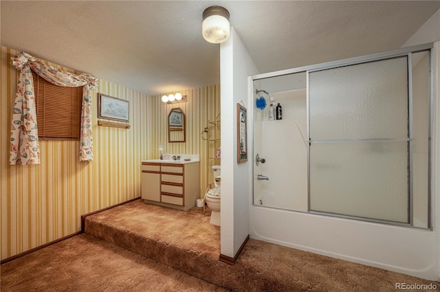 full bathroom featuring enclosed tub / shower combo, vanity, toilet, and a textured ceiling