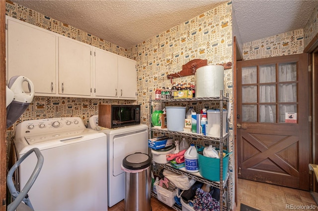 laundry room with independent washer and dryer, parquet floors, cabinets, and a textured ceiling