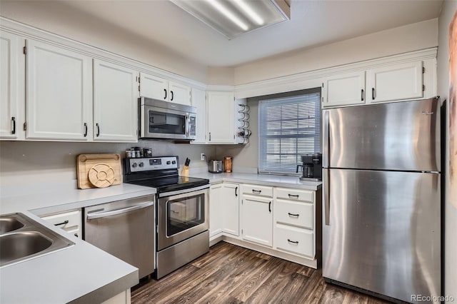 kitchen with stainless steel appliances, light countertops, and white cabinets