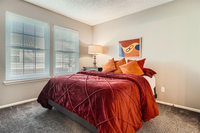 carpeted bedroom with baseboards and a textured ceiling