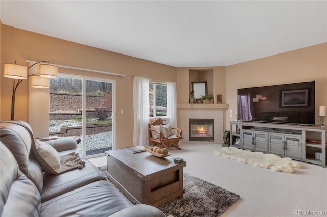 living area with carpet flooring and a tiled fireplace