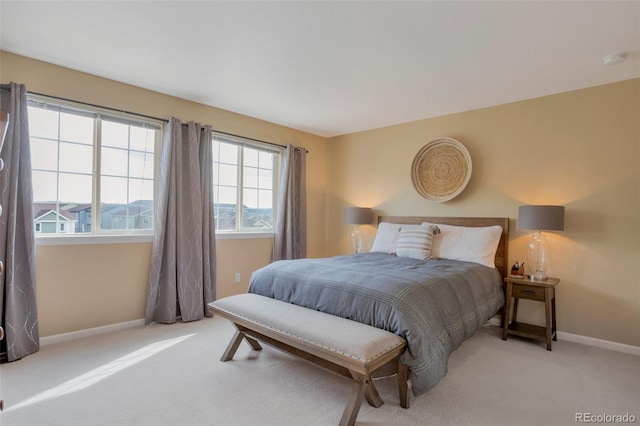 bedroom with baseboards and carpet