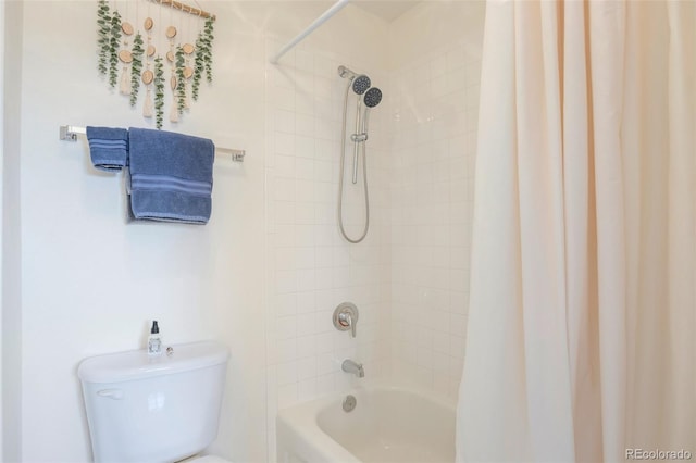 full bath with shower / bath combo with shower curtain and toilet
