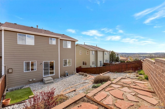 rear view of property featuring a fenced backyard