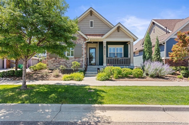 8272 E 55th Pl, Denver, CO 80238 - craftsman inspired home with a porch, a front yard, and brick siding