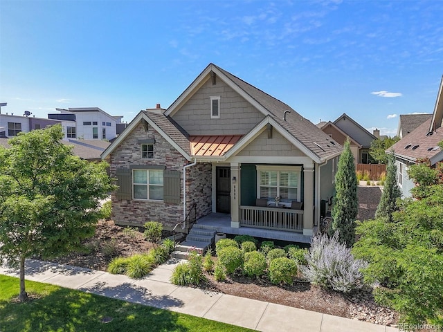 8272 E 55th Pl, Denver, CO 80238 - craftsman inspired home with a porch, stone siding, a standing seam roof, a chimney, and a metal roof