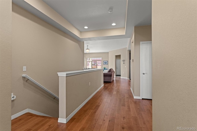 8272 E 55th Pl, Denver, CO 80238 - hallway with an upstairs landing, hardwood / wood-style flooring, recessed lighting, and a raised ceiling