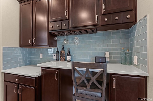 8272 E 55th Pl, Denver, CO 80238 - kitchen with decorative backsplash, dark brown cabinetry, and light countertops