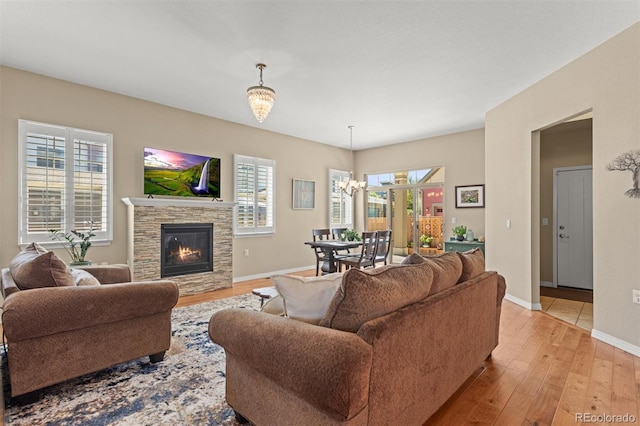 8272 E 55th Pl, Denver, CO 80238 - living room featuring light wood-style floors, a fireplace, and plenty of natural light