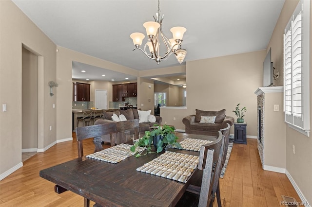 8272 E 55th Pl, Denver, CO 80238 - dining space with light wood-style flooring and a chandelier