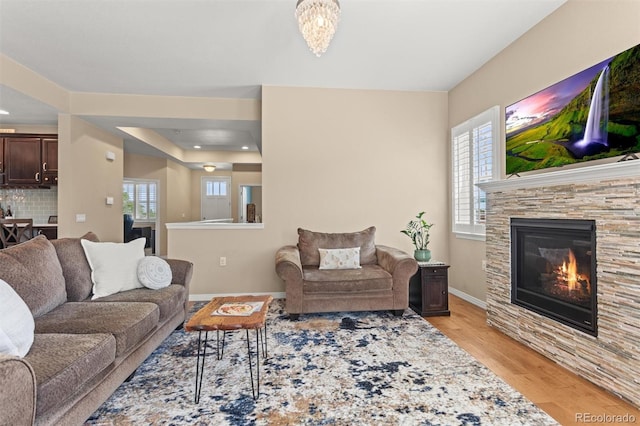 8272 E 55th Pl, Denver, CO 80238 - living area with light wood-style flooring and a stone fireplace