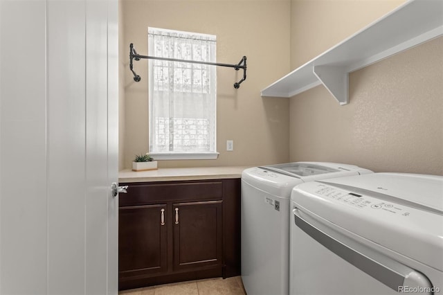 8272 E 55th Pl, Denver, CO 80238 - laundry area featuring washer and clothes dryer, plenty of natural light, cabinet space, and light tile patterned floors