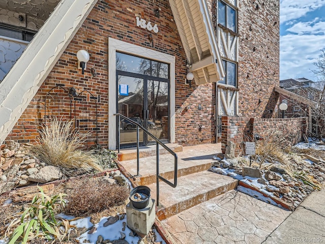 view of exterior entry with brick siding