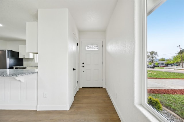 entryway featuring wood finished floors and baseboards