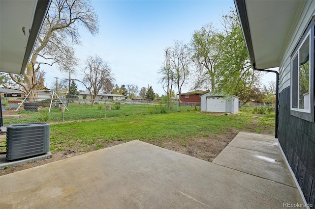 view of yard with fence, a patio, cooling unit, and an outdoor structure