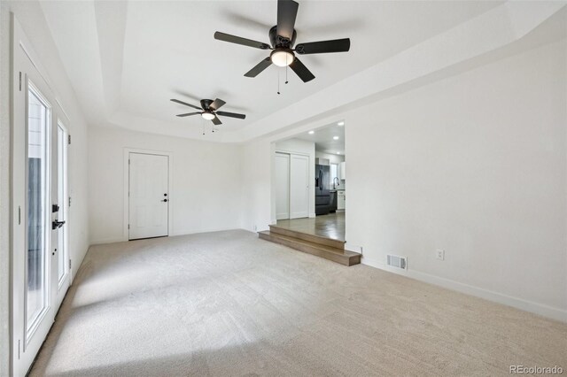 7780 Osceola St, Westminster, CO 80030 - empty room featuring ceiling fan, light colored carpet, a raised ceiling, and recessed lighting
