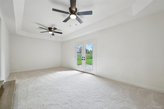 7780 Osceola St, Westminster, CO 80030 - carpeted spare room featuring a tray ceiling, french doors, and a ceiling fan