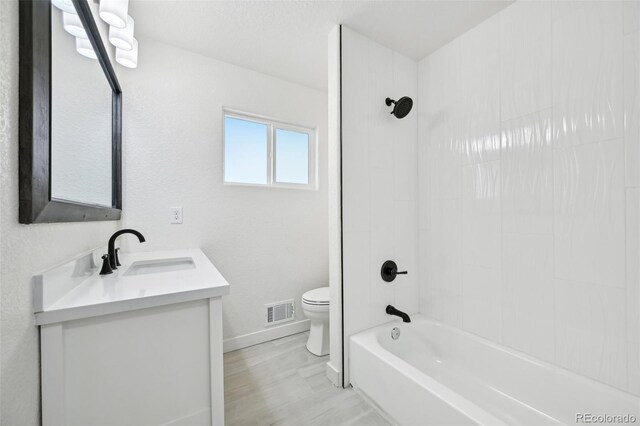 7780 Osceola St, Westminster, CO 80030 - full bath with vanity, shower / tub combination, and wood finished floors