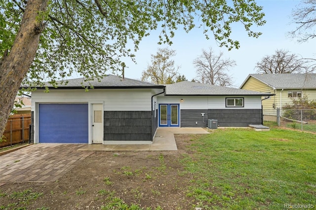7780 Osceola St, Westminster, CO 80030 - rear view of house with dirt driveway, a garage, french doors, and a shingled roof