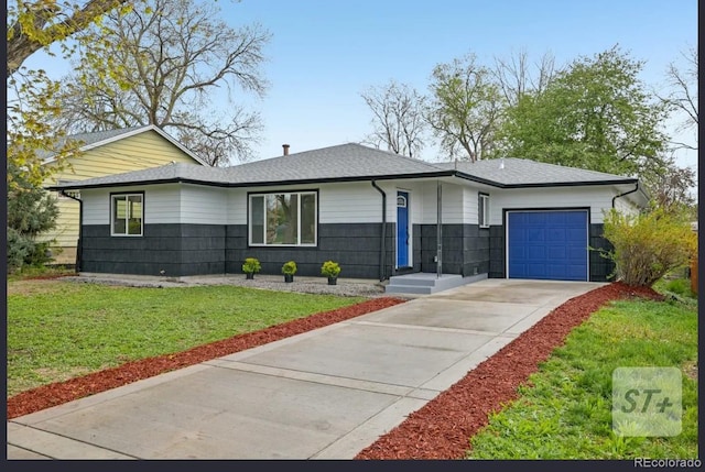 7780 Osceola St, Westminster, CO 80030 - view of front of property with an attached garage, driveway, a front lawn, and a shingled roof