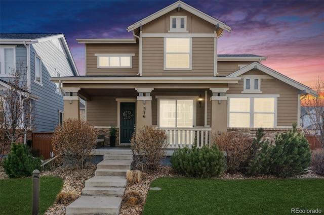 view of front of house with a lawn and a porch