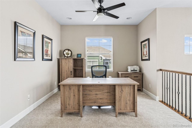 office space featuring light colored carpet and ceiling fan